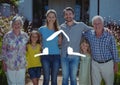 Home outline with multi generation family standing in background Royalty Free Stock Photo