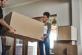 Home owner couple moving boxes into new home looking cheerful or excited inside their real estate house or living room Royalty Free Stock Photo