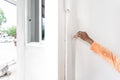 Home PaintBush in professional worker man hand is painting interior in the corner of the wall Royalty Free Stock Photo