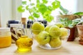 Home pantry, plants in pots, honey, chocolate paste, apples, bottle of olive oil Royalty Free Stock Photo