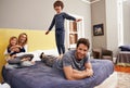 Home, parents and kids fun on bed with love, support and bonding together with a smile. Happy, family and children with Royalty Free Stock Photo