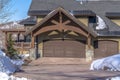 Home in Park City Utah in winter with gabled garage entrance against blue sky Royalty Free Stock Photo