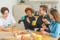 Home party. Friends spending time together having fun laughing communicating at home. Happy diverse group eating pizza Royalty Free Stock Photo