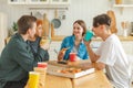 Home party. Friends spending time together having fun laughing communicating at home. Happy diverse group eating pizza Royalty Free Stock Photo