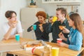 Home party. Friends spending time together having fun laughing communicating at home. Happy diverse group eating pizza Royalty Free Stock Photo