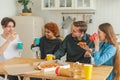 Home party. Friends spending time together having fun laughing communicating at home. Happy diverse group eating pizza Royalty Free Stock Photo