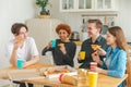 Home party. Friends spending time together having fun laughing communicating at home. Happy diverse group eating pizza Royalty Free Stock Photo