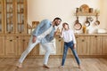 Cheerful Dad And Daughter Dancing And Singing In Modern Kitchen