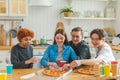 Home party. Overjoyed diverse friends eating ordered pizza for home party. Happy group mixed race young buddies enjoying