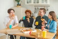 Home party. Overjoyed diverse friends eating ordered pizza for home party. Happy group mixed race young buddies enjoying Royalty Free Stock Photo