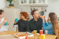 Home party. Overjoyed diverse friends eating ordered pizza for home party. Happy group mixed race young buddies enjoying Royalty Free Stock Photo