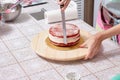 Home pastry chef teaches alignment the cake Royalty Free Stock Photo
