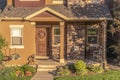 Home with pathway leading to gabled entrance of the front porch with brown door Royalty Free Stock Photo