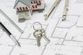 Home, Pencil, Ruler, Compass and Key Resting on House Plans Royalty Free Stock Photo