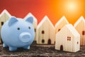 Home with piggy bank for money saving for house income and save cost concept Royalty Free Stock Photo