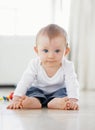 Home, playing and face of baby on floor to relax, resting and calm in nursery learning to crawl in morning. Family Royalty Free Stock Photo