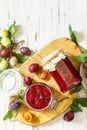 Delicious plum jam on a wooden table. Top view flat lay. Copy space