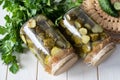 Home preservation for the winter: pickled cucumbers, sliced with mustard in glass jars on a white background. Close-up Royalty Free Stock Photo