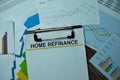 Home Refinance write on sticky notes with graphs and diagram isolated on office desk