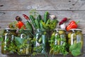 Home remedies for future use.Fresh and pickled cucumbers, homemade canned food with cucumbers in glass jars on a wooden background Royalty Free Stock Photo