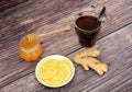 Home remedy for colds, honey, lemon, ginger root and a cup of hot tea on a wooden table Royalty Free Stock Photo