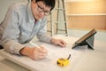 Asian male Interior worker working with architectural drawing Royalty Free Stock Photo