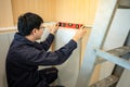 Asian male furniture assembler using spirit level tool Royalty Free Stock Photo