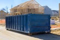 Home renovation maintenance a loaded dumpster near a construction Royalty Free Stock Photo