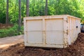 Home renovation maintenance a loaded dumpster near a construction Royalty Free Stock Photo