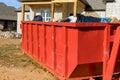 Home renovation maintenance a loaded dumpster near a construction Royalty Free Stock Photo