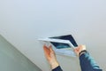 Home renovation project involving ceiling access hatch installation in a modern interior setting