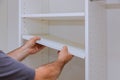 Worker sets the shelf for closet cabinet Royalty Free Stock Photo