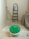Home renovation using tools, a stepladder, a bucket of paint, and an unfinished staircase. DIY home improvement Royalty Free Stock Photo