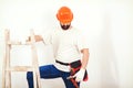 Home renovations service. Painter man at work. Handyman with a tool belt Royalty Free Stock Photo