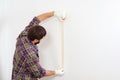 Home renovations service. Painter using masking tape before painting. Painter man at work Royalty Free Stock Photo