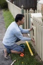 Home renovator installing a new mailbox