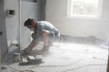 Home renovator using power tools cutting into a wall Royalty Free Stock Photo