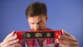 Home repair concept. Young man holding leveler. Selective focus. copy space Royalty Free Stock Photo