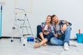 Home repair. Couple on break drinking coffee, taking a break from painting Royalty Free Stock Photo