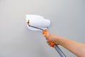 Home repairman paint the walls gray walls, painters use white paint brush rolls.soft focus