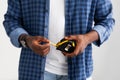 Home repairman. Unrecognizable black man holding measuring tape over white studio background, studio shot, closeup