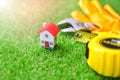 Miniature house with a building equipment on a grass