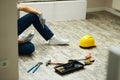 Home repairs. Cropped shot of handyman holding screwdriver and wall plug socket. Home repair hand tools on laminate