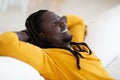 Home Rest. Portrait Of Smiling Young Black Man Leaning Back On Couch Royalty Free Stock Photo