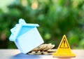 Home, Risky coin stack and Warning label.Financial crisis concept.Investing to buy a home is risky. Royalty Free Stock Photo