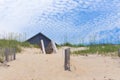 Home roof behind sand dunes 1