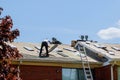 Home roof construction applying roof new shingles Royalty Free Stock Photo