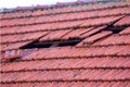 Home roof damage after storm. fallen shingles on house Royalty Free Stock Photo