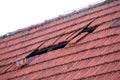 Home roof damage after storm. fallen shingles on house Royalty Free Stock Photo