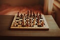 At home in a room on a gray table there is a chess board with figures. There\'s no one in the room. A logic game.
